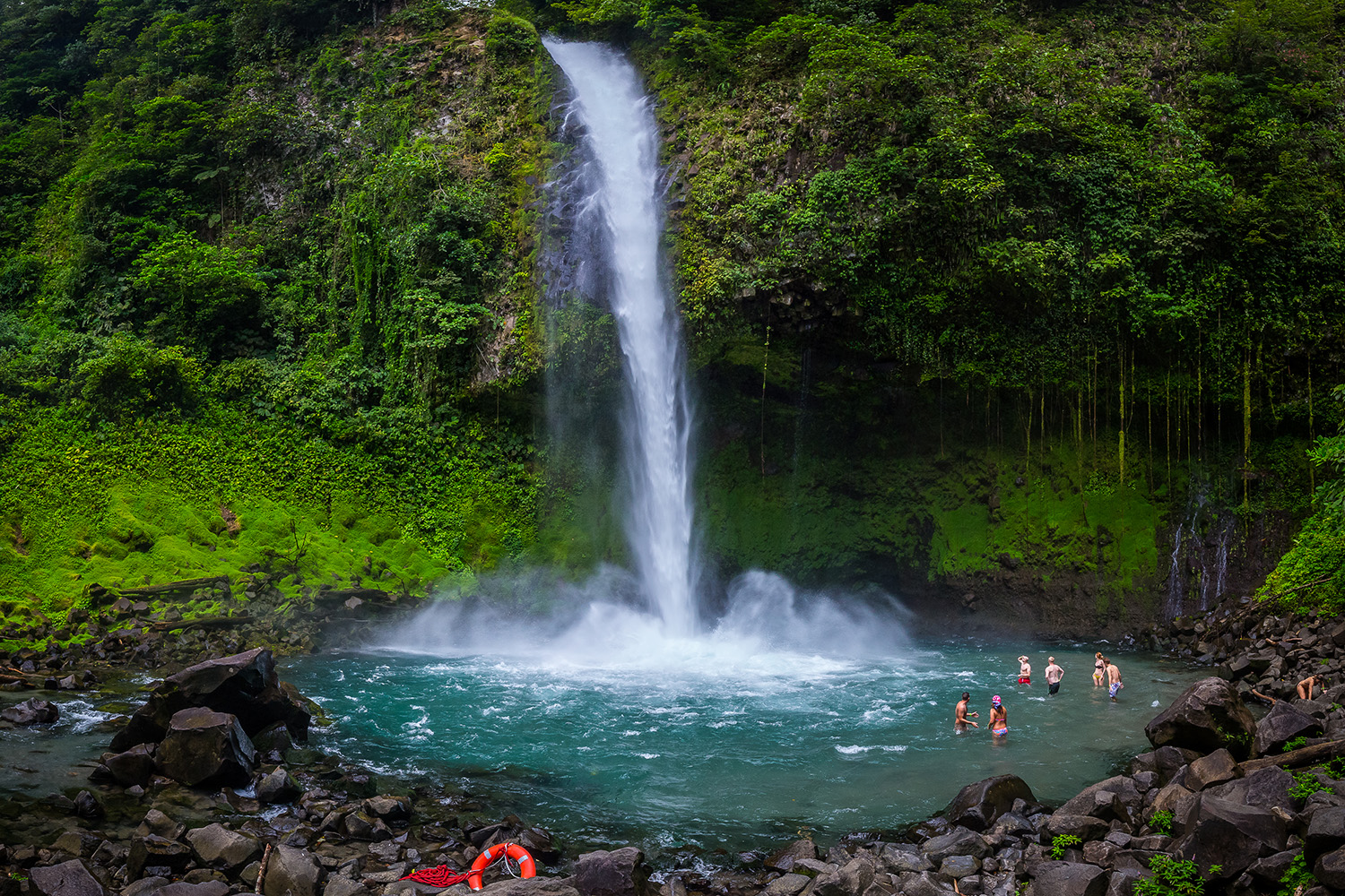 people swimming in the La Fortuna waterfall pool, Arenal, Costa Rica, Llama Travel