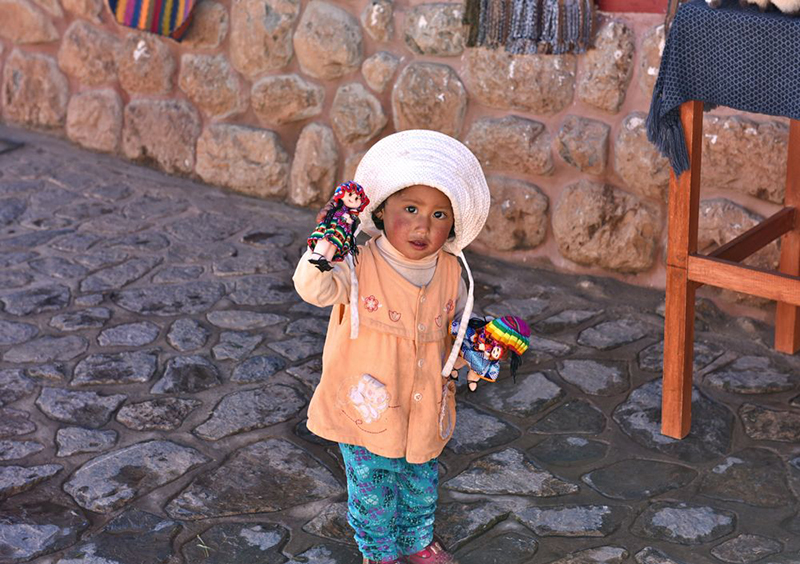 Little girl in Chincheros Peru Llama Travel