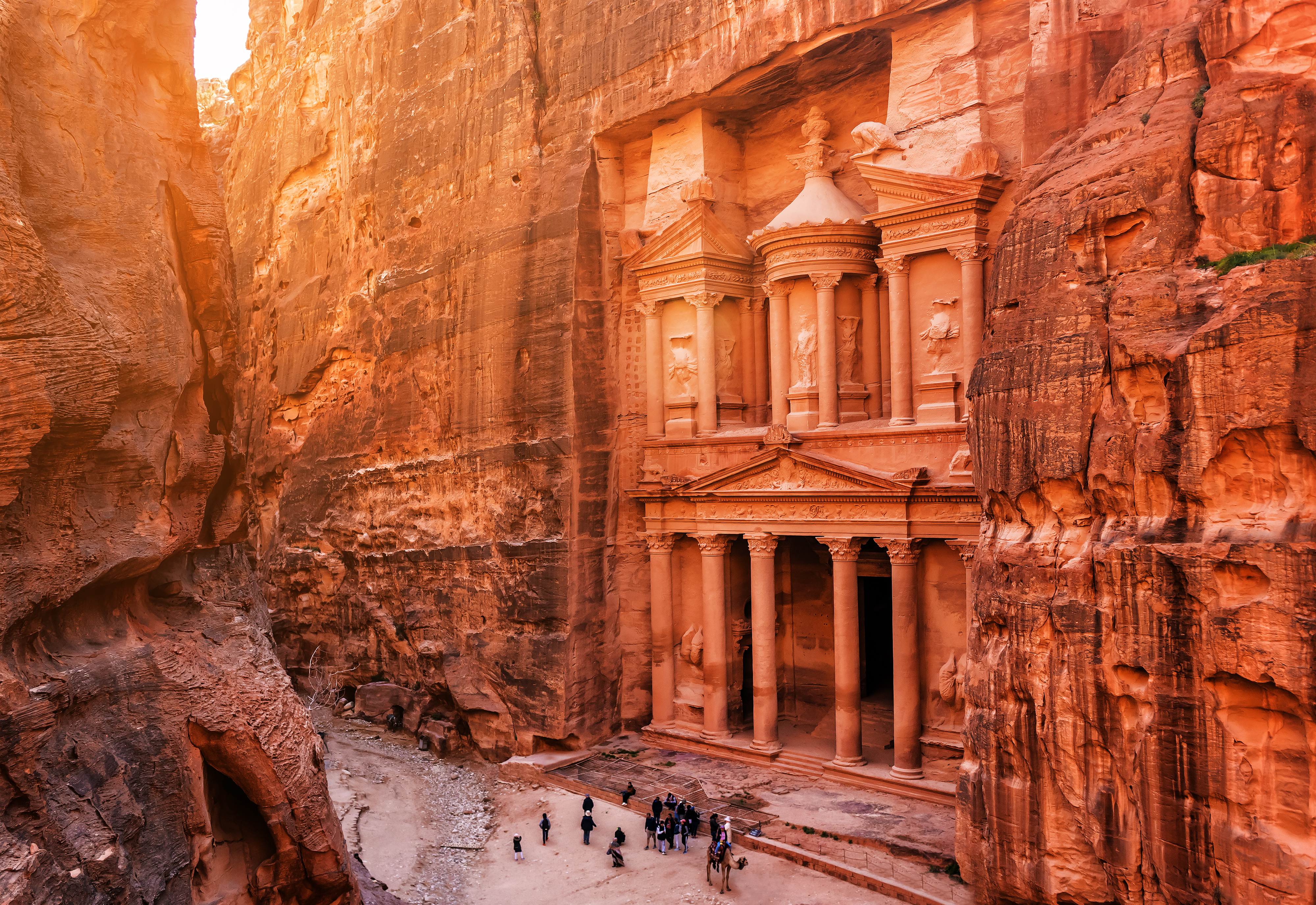 People stood at the entry to The Treasury at Petra, Jordan.