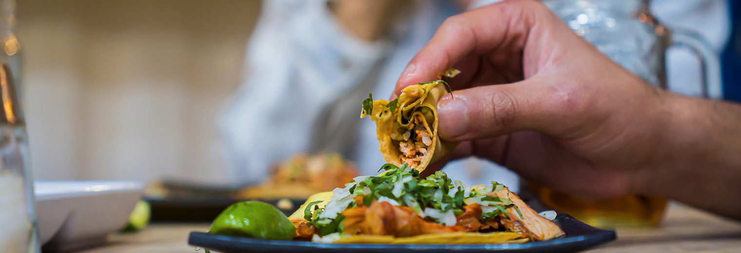 Man eating an Al Pastor Taco, Mexico City